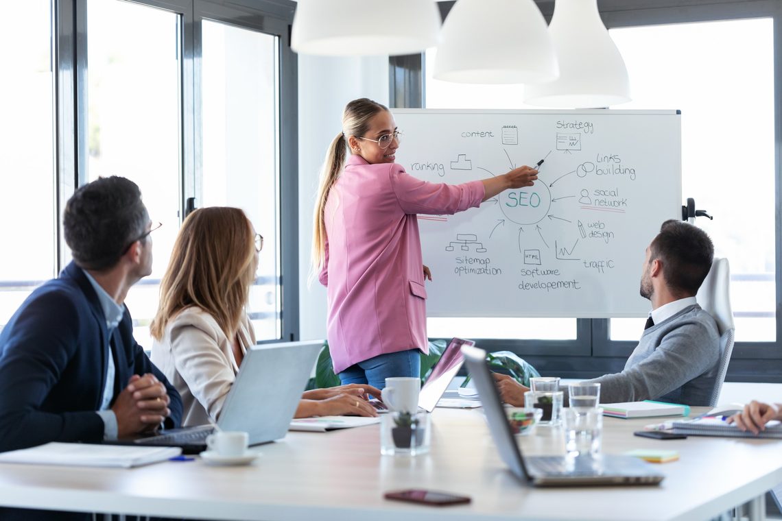Team meeting around a presentation board